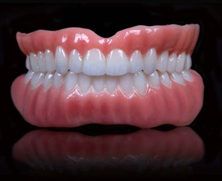 Complete denture appliance displayed on a clinical background